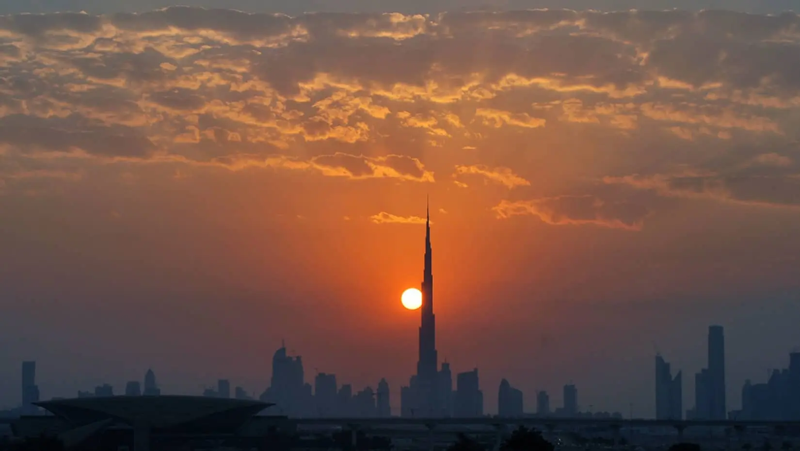 sun setting behind the Burj Khalifa
